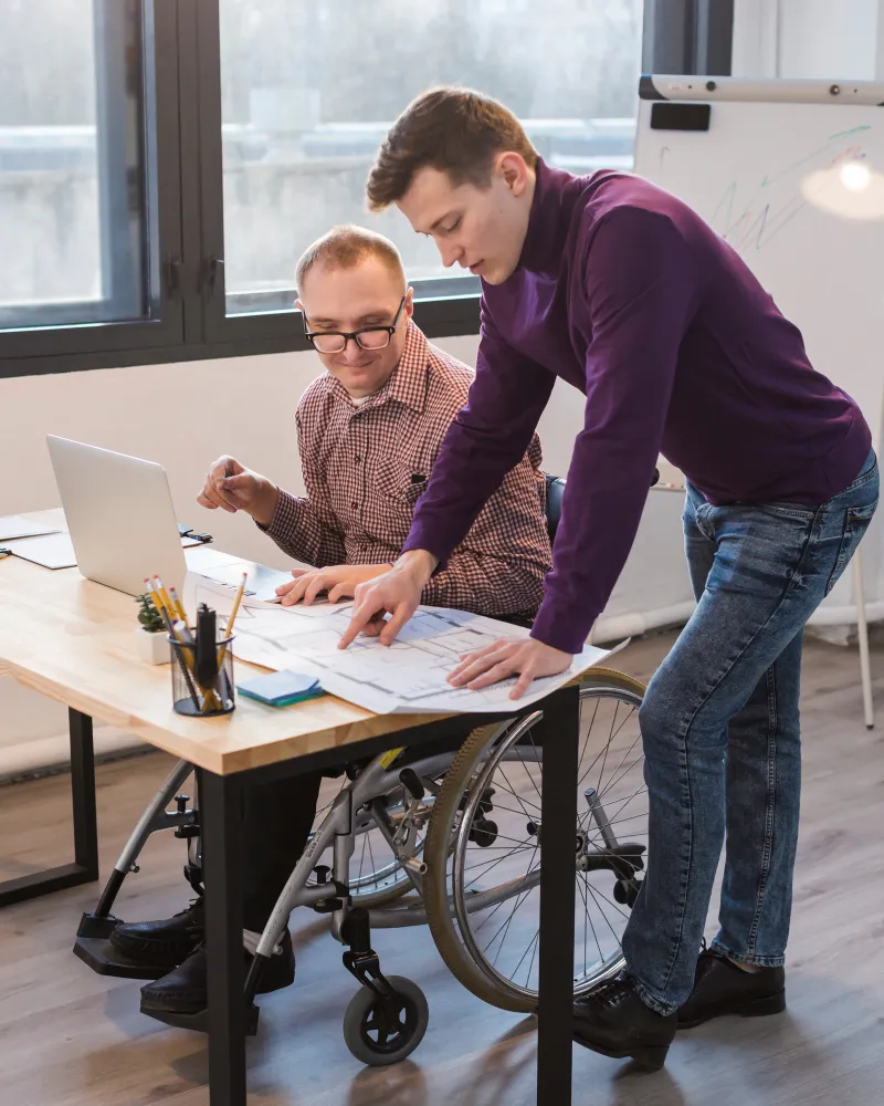 man showing another a vocational rehabilitation software